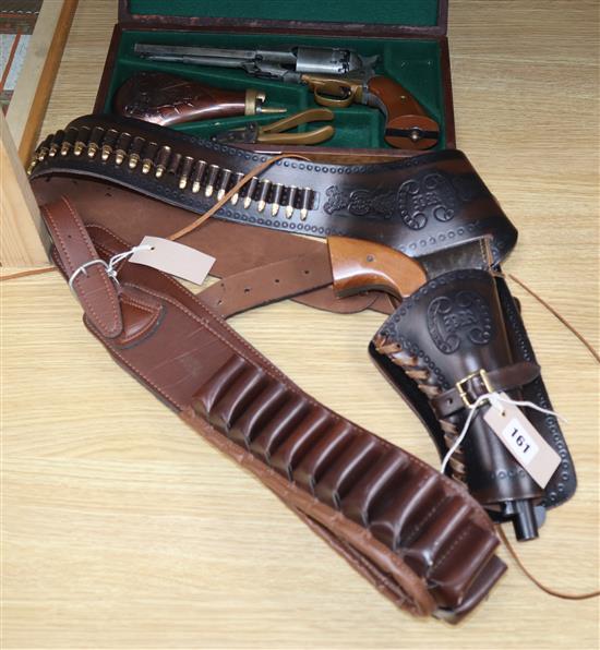 A cased model revolver, a model revolver on holster and a 12 bore cartridge belt